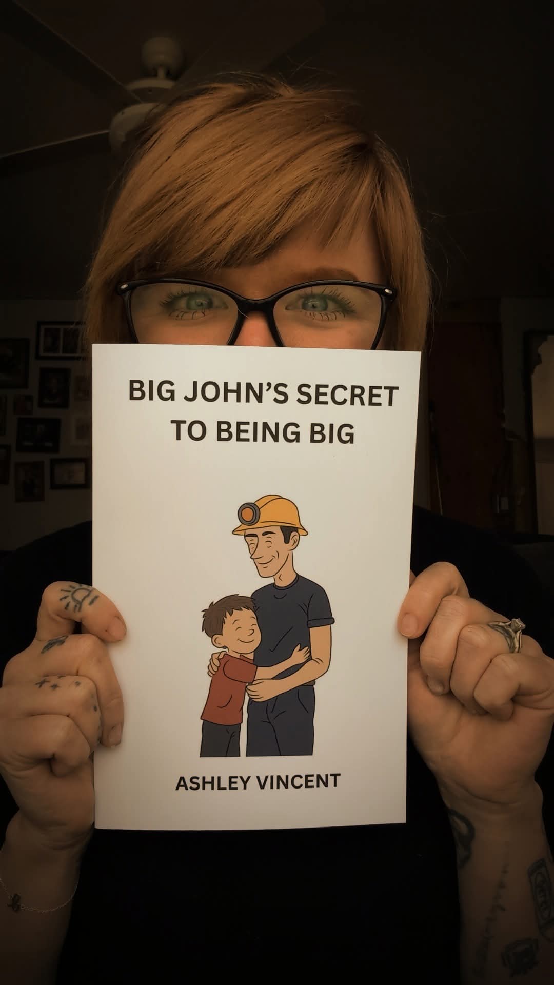 Ashley Vincent holding a copy of Big John's Secret to Being Big